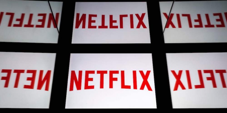 (FILES) In this file photo taken on February 18, 2019 This illustration picture shows the US Online Streaming giant Netflix logo displayed on a tablet in Paris. - Some of the biggest names in media and tech are gearing up to move into streaming, in what could be a major challenge to market leader Netflix. Apple is expected to make its move with an announcement March 25 on its media plans, with a war chest estimated at some $1 billion and partners including stars like Jennifer Aniston and director J.J. Abrams involved in content. (Photo by Lionel BONAVENTURE / AFP)