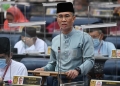 Tengku Datuk Seri Zafrul Abdul Aziz delivering Budget 2021 in Parliament.