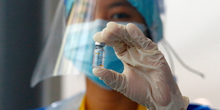 A medical worker shows a bottle of the Sinovac vaccine at the emergency hospital for the coronavirus disease (COVID-19) patients in the Athlete Village in Jakarta, Indonesia, January 27, 2021. REUTERS/Ajeng Dinar Ulfiana